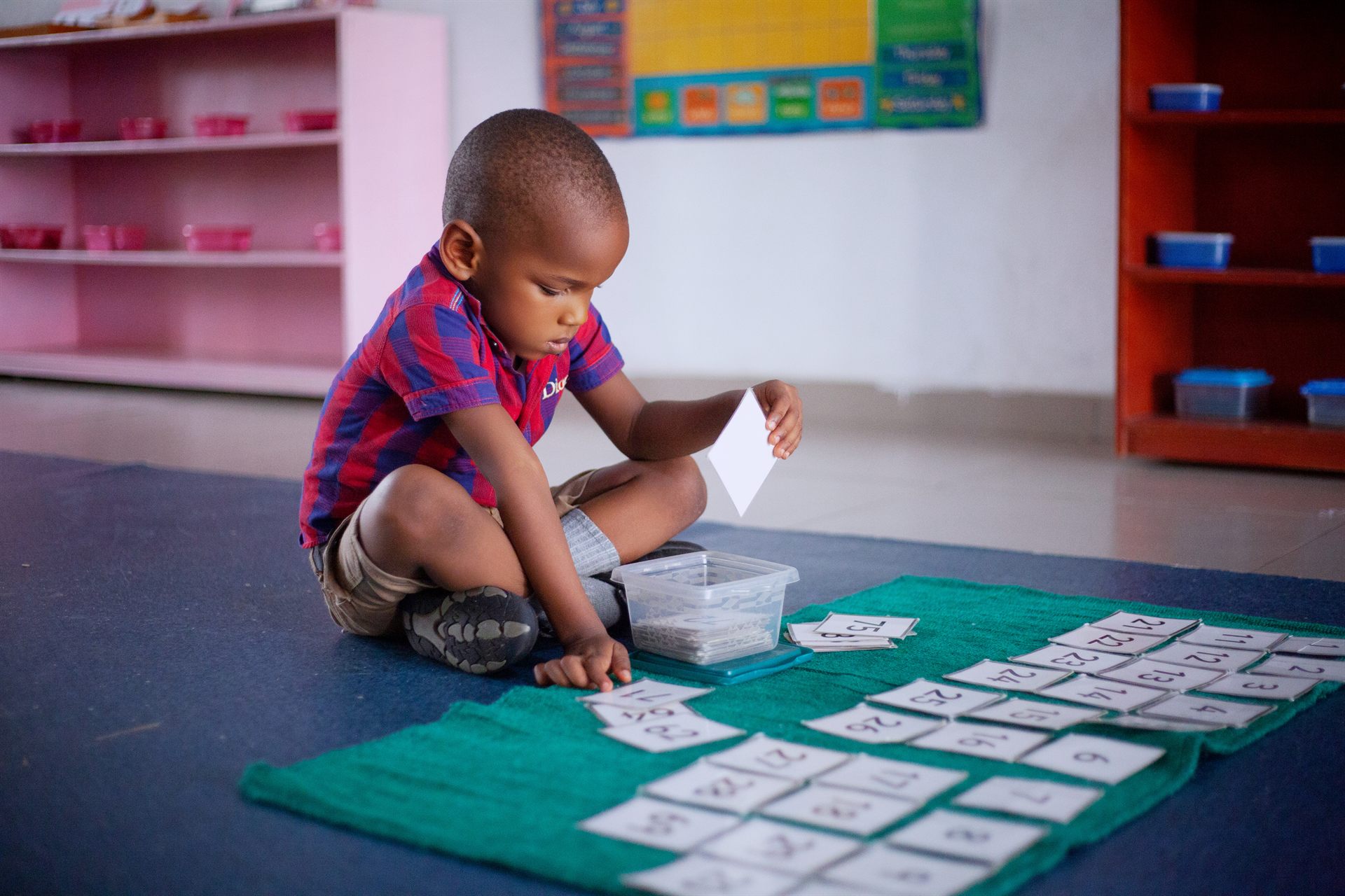 A pupil in the Infant Centre / Toddlers' Class working with number cards
