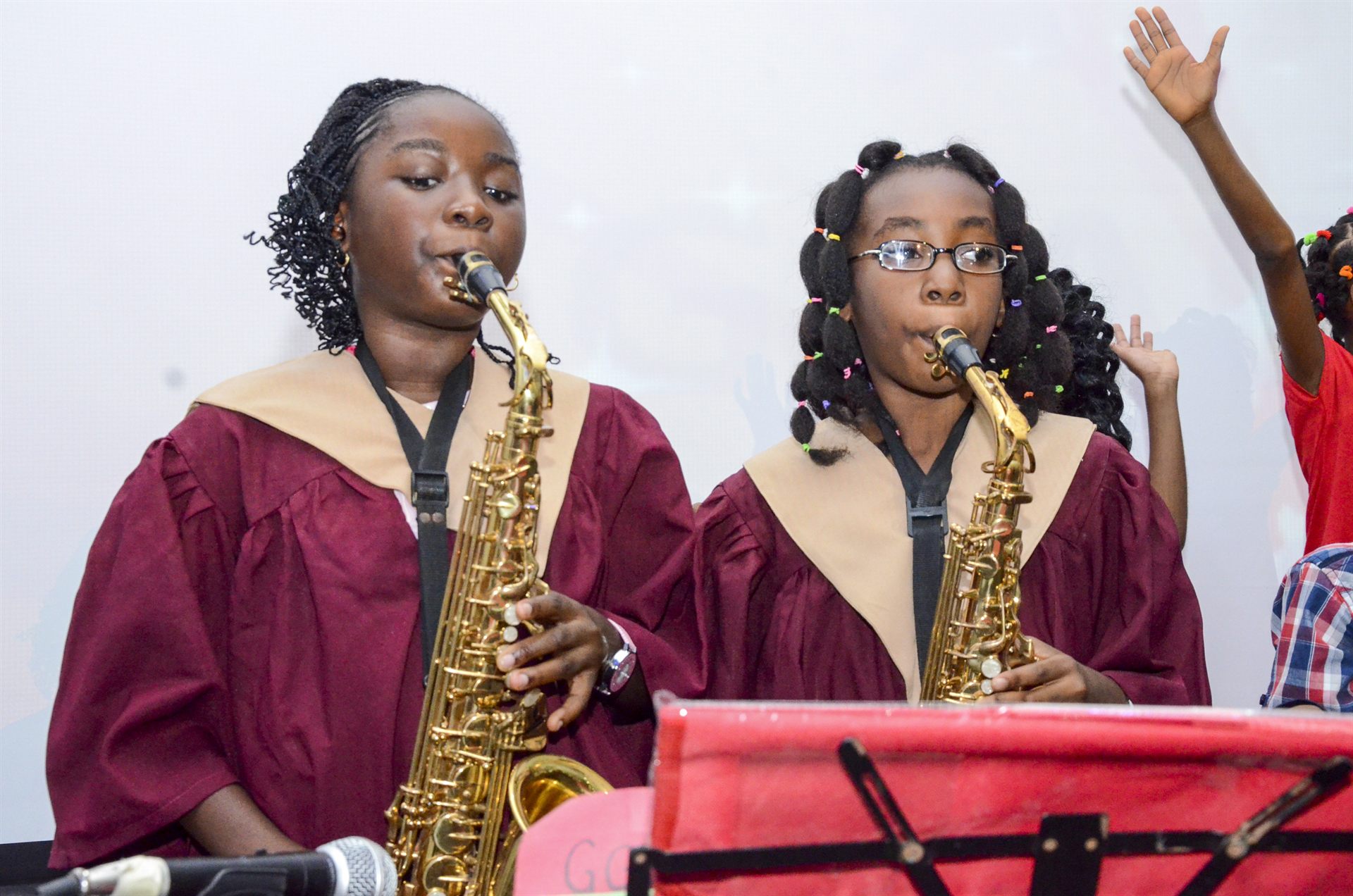 Two Accolade House pupils playing saxophone at a school event