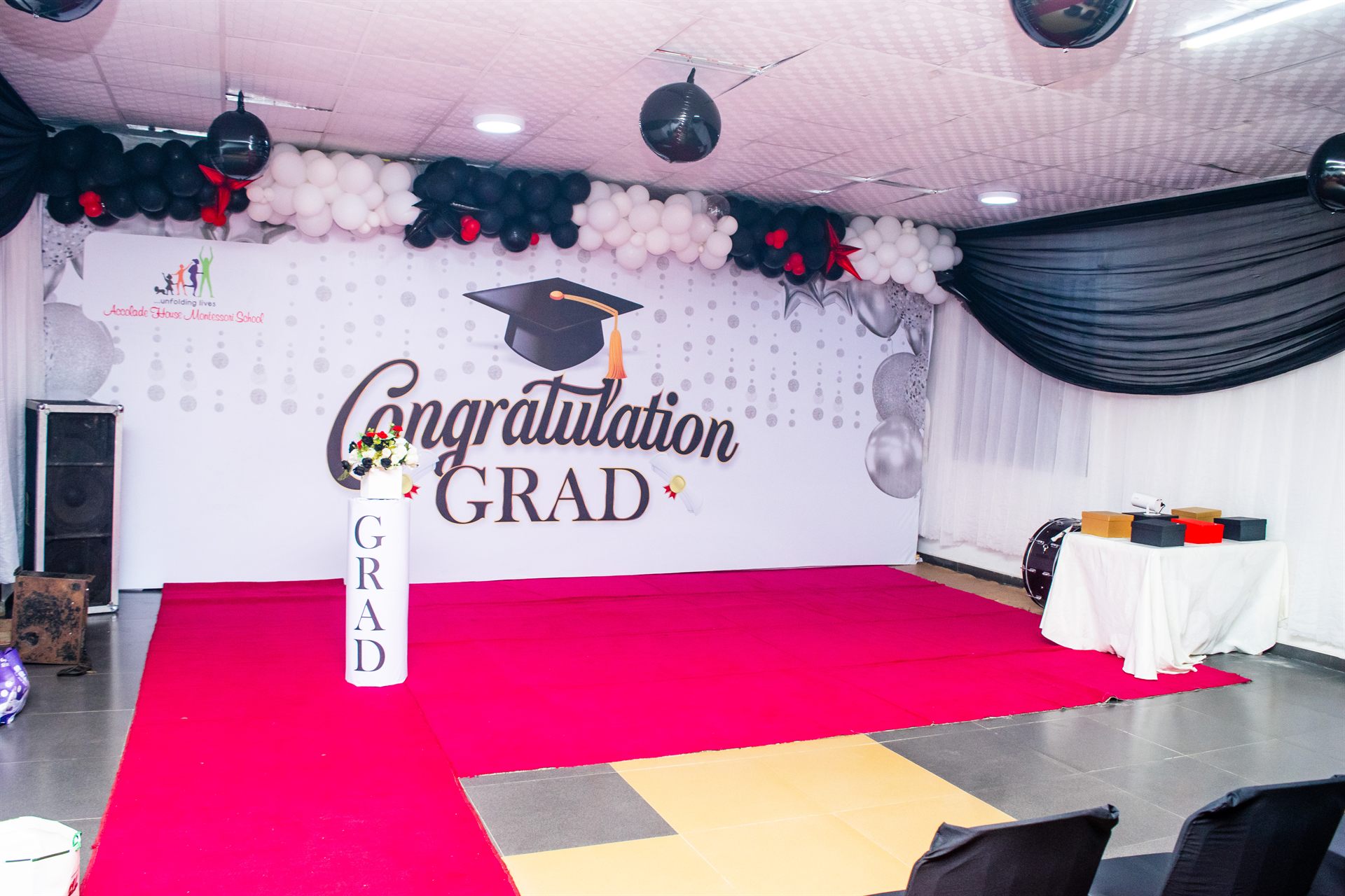 Accolade House graduation stage decorated with the school crest