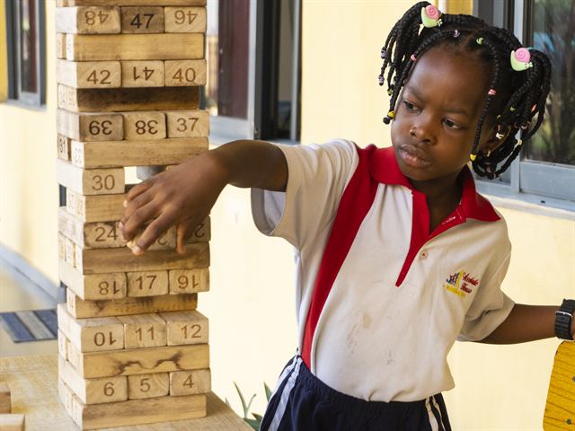 Pupil in Accolade House uniform playing Jenga
