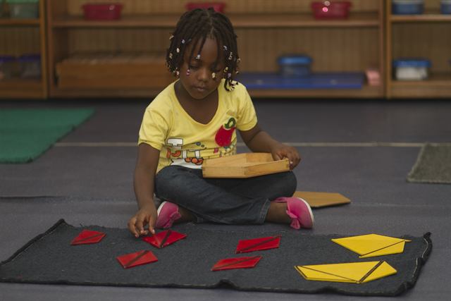 Pupil with Montessori constructive triangles
